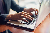 Close up of a hands of a businessman on a keyboard.