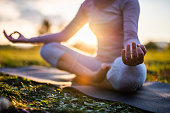 Close up of meditation in park at sunrise.