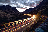 Light trails in the night on a remote road in mountains