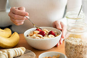 Woman eating oatmeal porridge