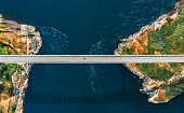 Aerial view Saltstraumen bridge in Norway road above sea connecting islands top down scenery transportation infrastructure famous landmarks scandinavian landscape