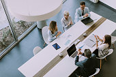 Aerial view at group of business people working together and preparing new project on a meeting in office