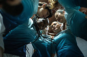 Female soccer team huddling in the locker room