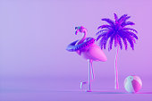 Inflatable flamingo with sunglasses and swim ring on neon purple background minimal summer travel holiday background