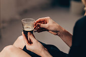 Anonymous White Woman Holding a Small Cup of Black Coffee