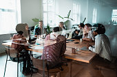 Colleagues at business meeting in conference room.