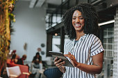 Business woman holding digital tablet smiling