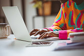 Woman typing on laptop keyboard