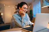 Young Caucasian woman, using laptop while working from home