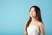 Front portrait of Asian young woman beautiful face closed eyes and smiling