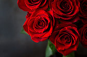 Bouquet of red roses on a black background. Top view