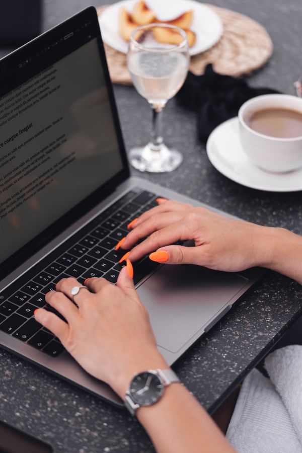 Woman Typing on Her Laptop During Morning Breakfast Free Photo