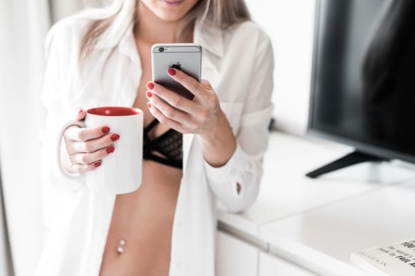 Woman Using Smartphone at Home Free Photo