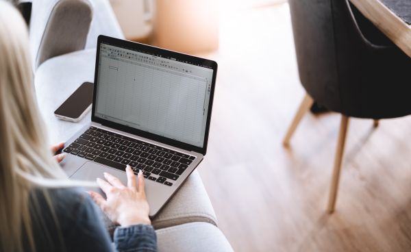 Woman Using Spreadsheet on Her Laptop at Home Free Stock Photo