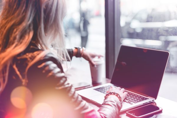 Young Freelance Woman Working Remotely from Café Free Photo