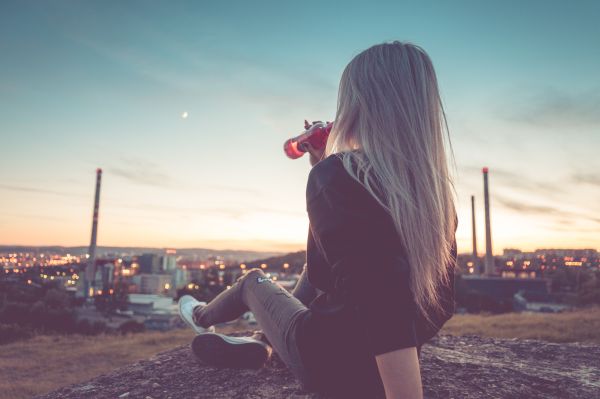 Young Woman Drinking Lemonade and Overlooking the City Free Photo